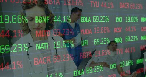 Doctor reviewing tablet with stock-ticker style health data overlay in hospital ward