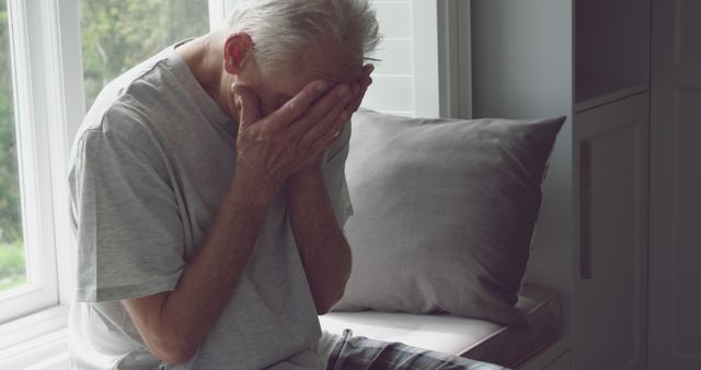 Depicting an elderly man experiencing sorrow, this image brings awareness to mental health, depression, and loneliness among seniors. Suitable for use in articles about elderly care, mental health awareness, grief counseling, emotional well-being, and social isolation.