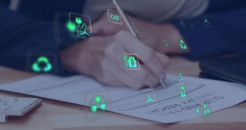 Executive signing sustainability report with green energy and analytics icons overlay