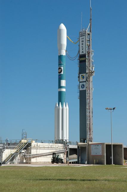 KENNEDY SPACE CENTER, FLA. -   The Delta II rocket with the STEREO spacecraft at top stands next to the launch gantry, ready for liftoff.  Launch is scheduled in a window between 8:38 and 8:53 p.m. on Oct. 25. STEREO (Solar Terrestrial Relations Observatory) is a two-year mission using two nearly identical observatories, one ahead of Earth in its orbit and the other trailing behind.  The duo will provide 3-D measurements of the sun and its flow of energy, enabling scientists to study the nature of coronal mass ejections and why they happen.  The ejections are a major source of the magnetic disruptions on Earth and are a key component of space weather.  The disruptions can greatly effect satellite operations, communications, power systems, humans in space and global climate.  Designed and built by the Johns Hopkins University Applied Physics Laboratory (APL) , the STEREO mission is being managed by NASA Goddard Space Flight Center. APL will maintain command and control of the observatories throughout the mission, while NASA tracks and receives the data, determines the orbit of the satellites, and coordinates the science results. Photo credit: NASA/Kim Shiflett