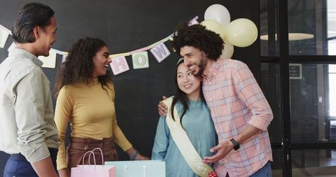 Diverse Team Celebrating Office Baby Shower with Joyful Interaction