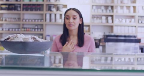 Young Biracial Woman Smiling Behind Store Counter - Download Free Stock Images Pikwizard.com