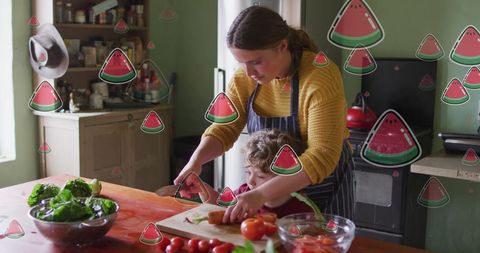 Mother and Son Cooking with Digital Overlay of Watermelon Icons
