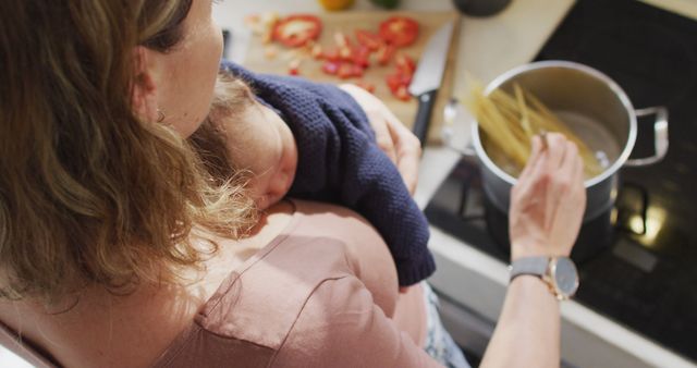 Mother Cooking Pasta While Holding Baby in Kitchen - Download Free Stock Images Pikwizard.com