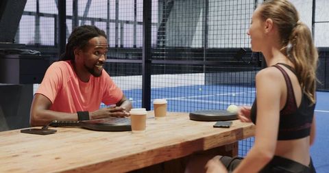 Athletes Relaxing with Coffee After Indoor Padel Match
