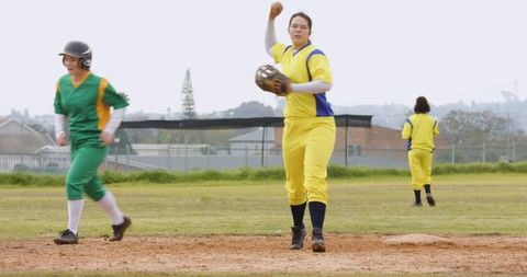 Female softball player making dynamic infield throw