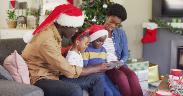 Happy african american family having tablet image call. Spending quality time with family at christmas concept.