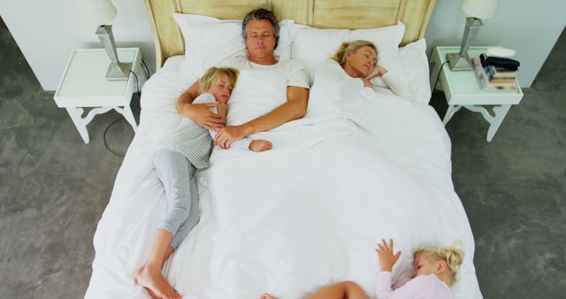 Happy family sleeping together in cozy bedroom - Download Free Stock Images Pikwizard.com