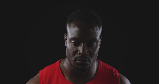 Man Reflecting in Red Athletic Shirt Against Black Background - Download Free Stock Images Pikwizard.com