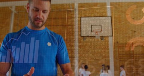 Youth basketball coach checking tablet with performance analytics overlay in school gym