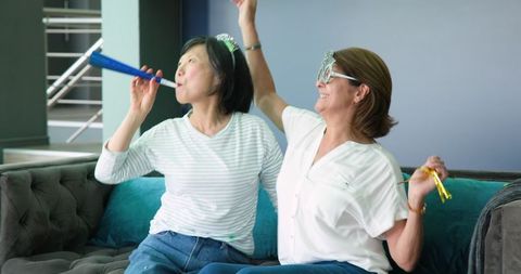 Joyful Senior Friends Celebrating with Party Horns
