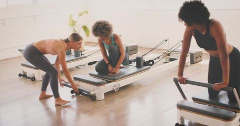 Diverse Group of Women Performing Pilates in Modern Studio - Download Free Stock Images Pikwizard.com