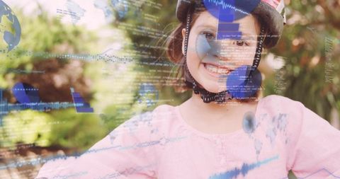 Smiling girl wearing bike helmet enjoying outdoor play with digital learning overlays