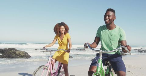 Happy Couple Riding Bicycles on Sunlit Beach - Download Free Stock Images Pikwizard.com