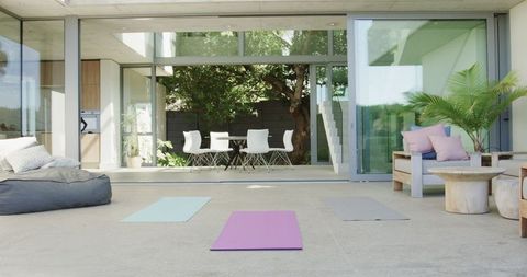 Luxurious Modern Patio Bask in Sunlight with Yoga Mats and Contemporary Furniture - Download Free Stock Images Pikwizard.com