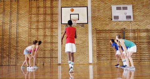 High School Students Playing Basketball Indoors