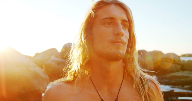 Serene Young Man with Long Blond Hair at Sunset Beach - Download Free Stock Images Pikwizard.com