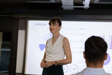 Professional businesswoman leading corporate presentation meeting