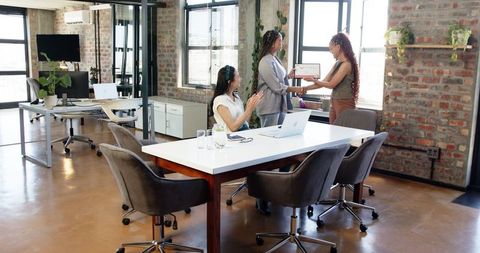 Multiracial Team Members Celebrating Success with Award