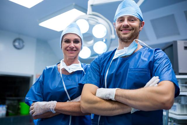 Portrait of surgeons standing with arms crossed in operation room - Download Free Stock Photos Pikwizard.com