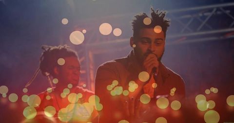 Energetic music performance with vibrant bokeh lights