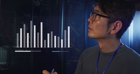 Asian IT Professional Analyzing Graphical Data in Server Room - Download Free Stock Images Pikwizard.com
