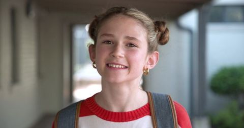 Youthful Girl with Denim Backpack in School Corridor
