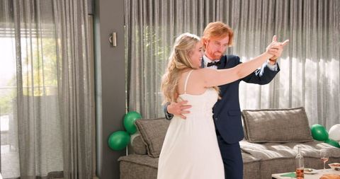 Joyful Bride and Groom Dancing at Home Wedding Reception