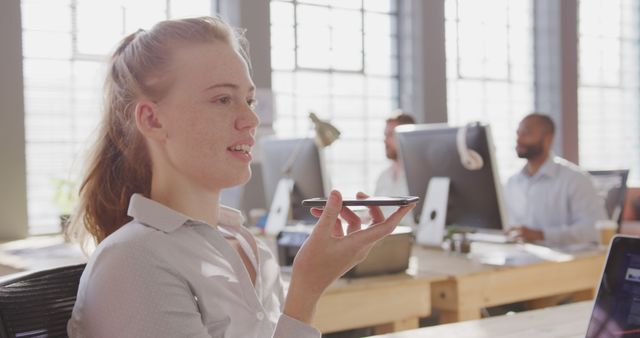 Businesswoman Using Voice Commands in Modern Office - Download Free Stock Images Pikwizard.com