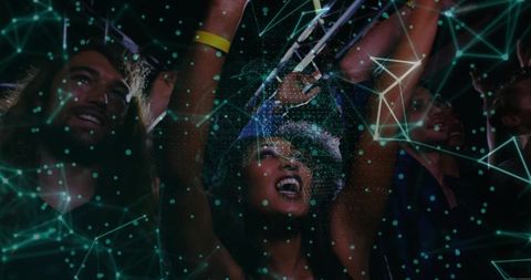 Exhilarated crowd celebrating at night concert with energetic atmosphere