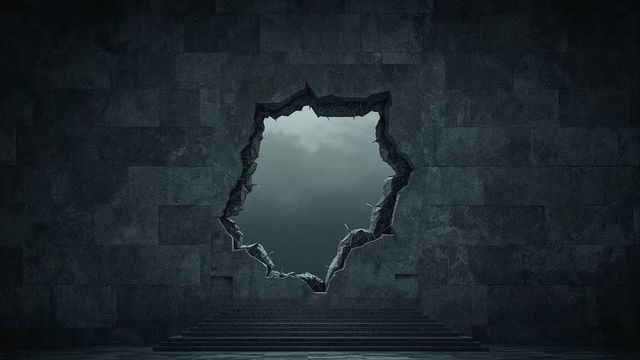 Jagged breach in stone wall revealing cloudy sky