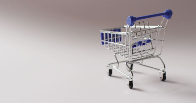 Empty blue shopping trolley on seamless grey background. Luxury treat, present, shopping, sale and retail concept digitally generated image.