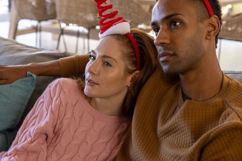 Diverse Couple Enjoying Festive Moments in Cozy Living Room