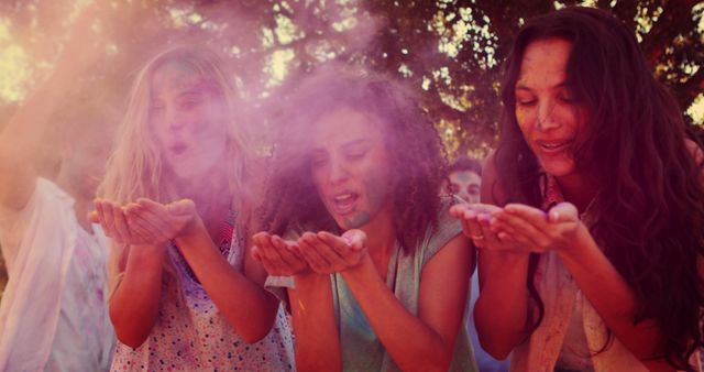 Young Friends Celebrating Holi Festival Blowing Colored Powder - Download Free Stock Images Pikwizard.com