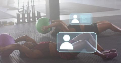 Backlit fitness partners crunching with medicine balls and ar hud tracking training