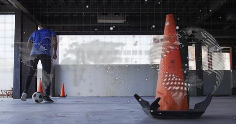Urban indoor soccer training with dribbling player, cone drills and digital globe overlay