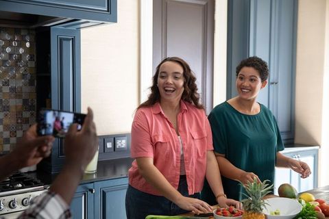 Diverse Female Friends Preparing Fresh Fruits in Stylish Kitchen