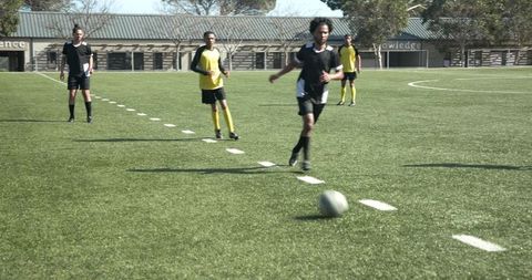 Dynamic Soccer Match on Sunny Athletic Field