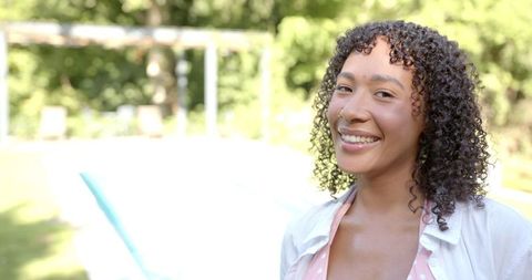 Woman Smiling by Poolside on Sunny Day for Leisure