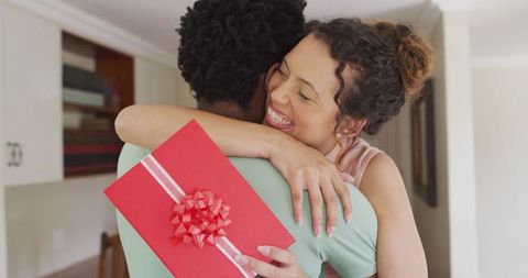 Happy Couple Embracing with Gift Celebrating Special Occasion