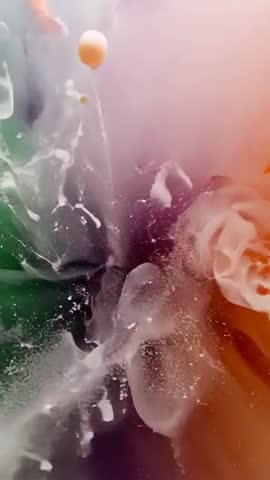 Vertical color plume exploding and mixing green pink orange pigments in water
