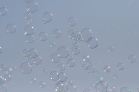 Floating Soap Bubbles Against Serene Sky