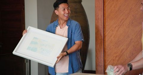 Couple Unpacking Art in New Home for Personal Touch