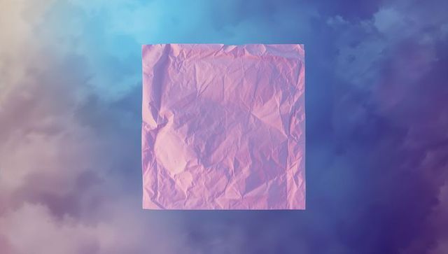 Floating wrinkled pink square against soft cloudscape