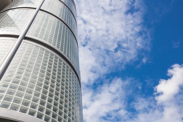 Low Angle View of Modern Skyscraper Against Blue Sky - Download Free Stock Photos Pikwizard.com