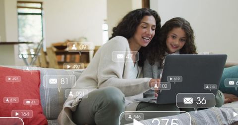 Mother and Daughter Engaging with Social Media on Laptop