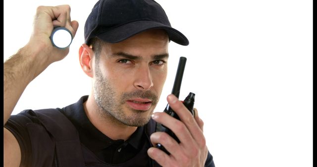 This is excellent for articles and advertisements about security services, emergency preparedness, and public safety tips. It can also be used by security companies for marketing collateral, websites, and promotional materials to depict a professional, vigilant security guard on duty, showcasing the tools used in the profession.