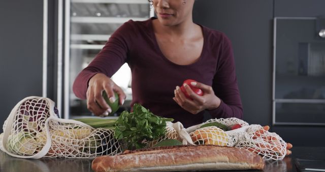 Woman Organizing Groceries in Kitchen with Reusable Bags - Download Free Stock Images Pikwizard.com