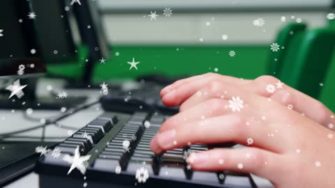 Child Typing on Computer with Magical Snowflake Overlay