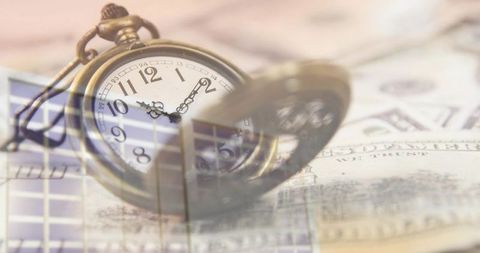 Antique pocket watch overlaid on us banknotes evoking time value of money and investment